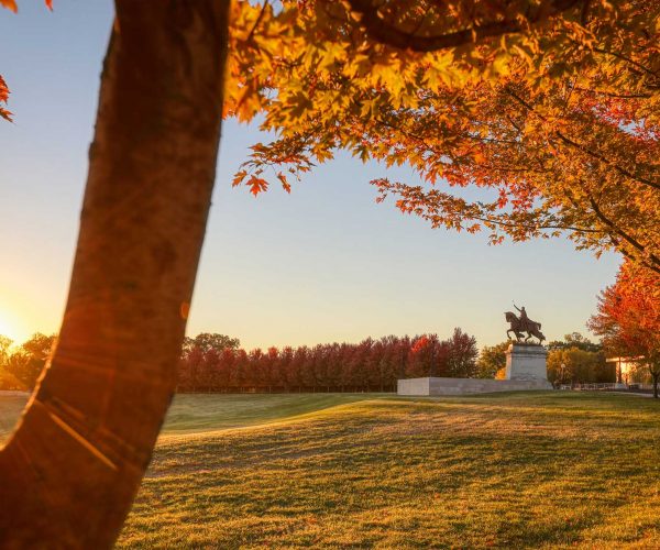 October 20, 2018 - St. Louis, Missouri - The sunrise and fall foliage around the Apotheosis of St. Louis statue of King Louis IX of France on Art Hill in Forest Park, St. Louis, Missouri.